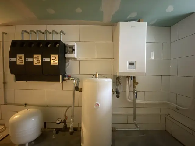 Boiler room with a gas boiler and a manifold