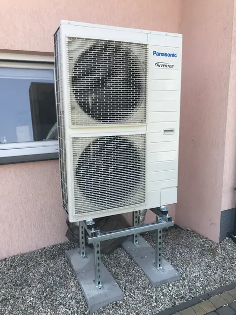 Heat pump on brackets by the facade