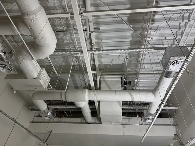 Large ventilation ducts below the ceiling